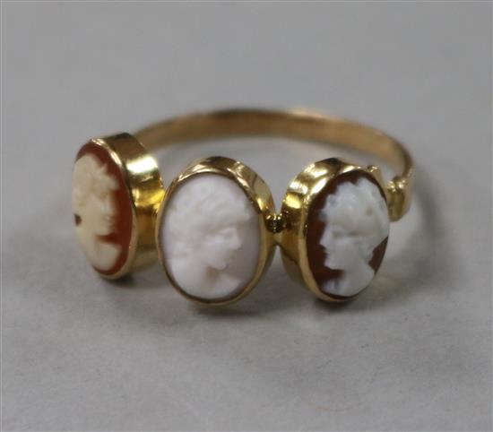 An early 20th century yellow metal and triple cameo ring, size N.